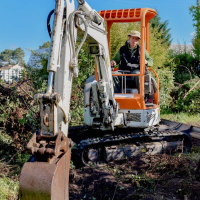 Man using a digger in the garden