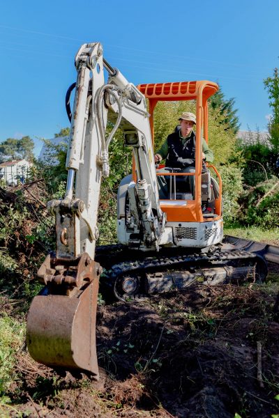 Man using a digger in the garden